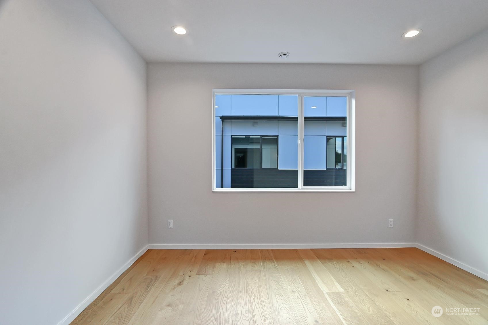 17342 Bothell Way Northeast, Unit H Bothell, WA 98011 - Photo 10 of 19 a view of a room with wooden floor and a window