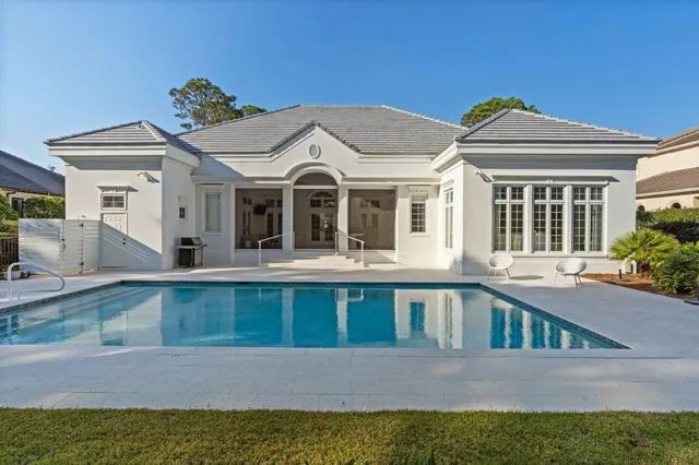 a view of yard with swimming pool and furniture