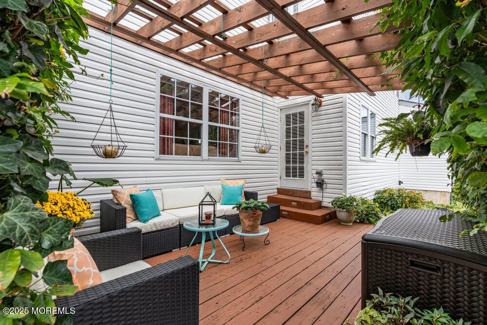 3 Harbor View Lane Toms River, NJ 08753 - Photo 39 of 61 a view of a patio with couches and table and chairs with wooden floor and fence