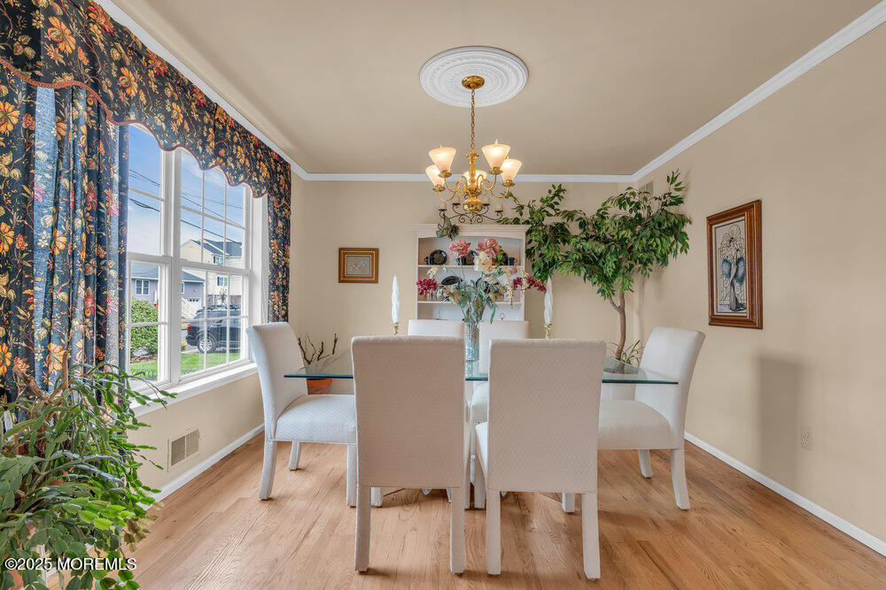 3 Harbor View Lane Toms River, NJ 08753 - Photo 9 of 61 a view of a dining room with furniture wooden floor and chandelier