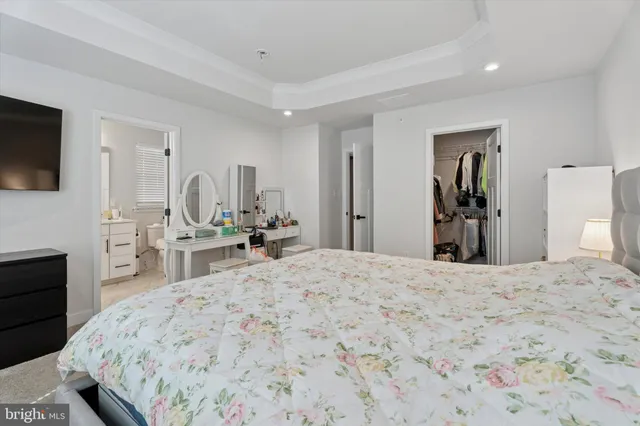 a view of a bedroom with furniture and flat screen tv