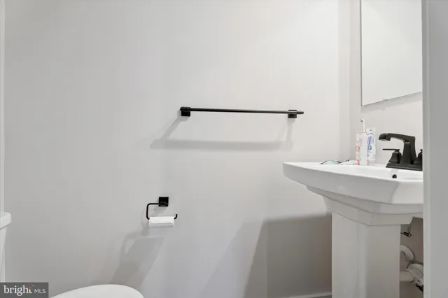 a bathroom with a sink a toilet and shower curtain