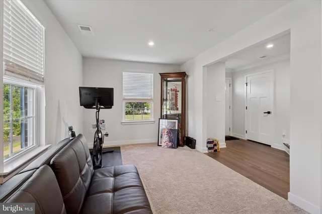 a view of a livingroom with furniture and a flat screen tv