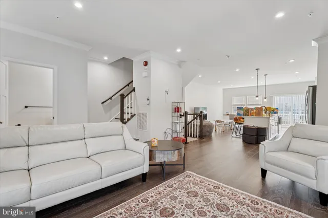 a living room with furniture and kitchen view