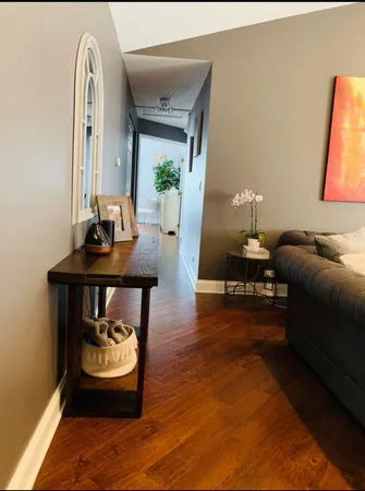 a living room with furniture and a wooden floor