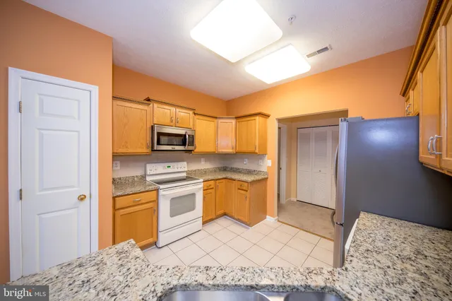a kitchen with a sink cabinets and stainless steel appliances