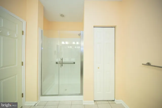 a bathroom with a glass shower door