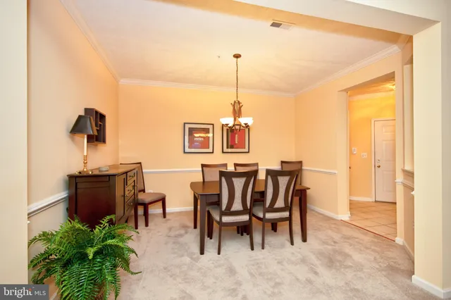 a dining room with furniture and a window