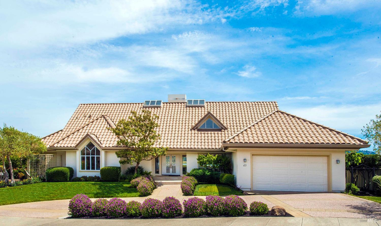 a front view of a house with a garden