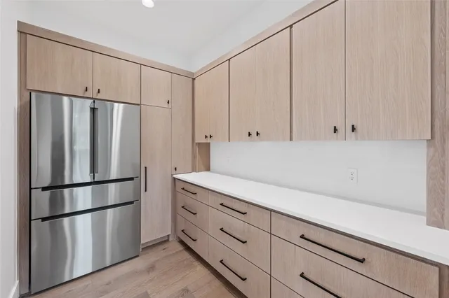 a kitchen with stainless steel appliances a refrigerator and cabinets