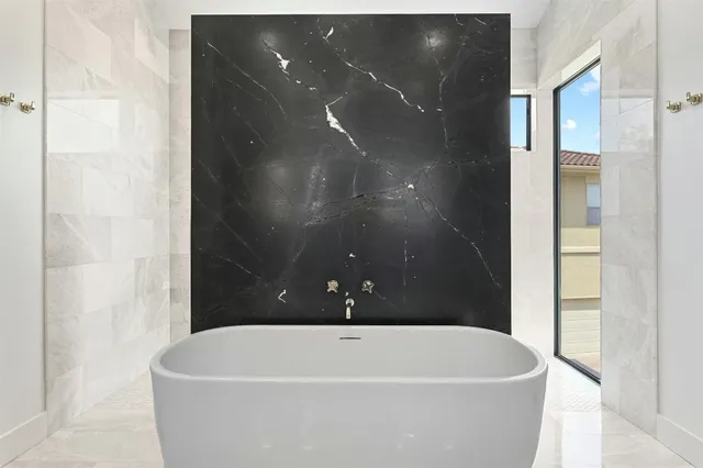 a white bath tub sitting in a bathroom