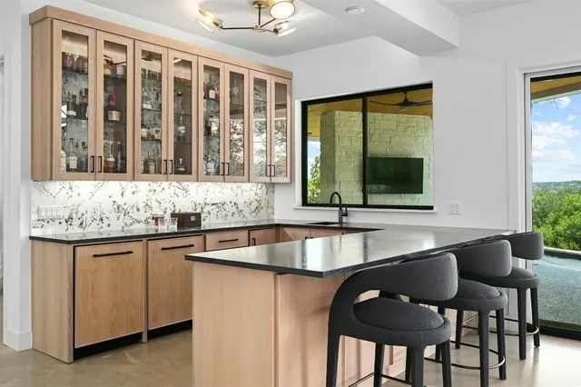 a large white kitchen with a large window