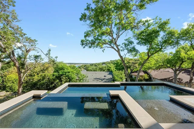 a living room with pool table and chairs
