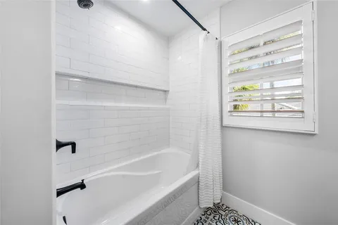 a backyard of a house with barbeque oven table and chairs