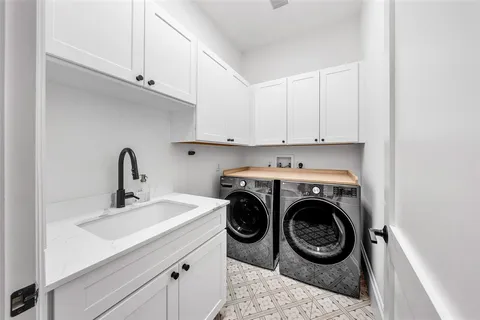 a front view of a house with a garden and trees