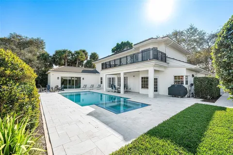 an aerial view of a house with a garden and lake view