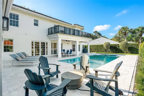 an aerial view of residential houses with outdoor space and trees