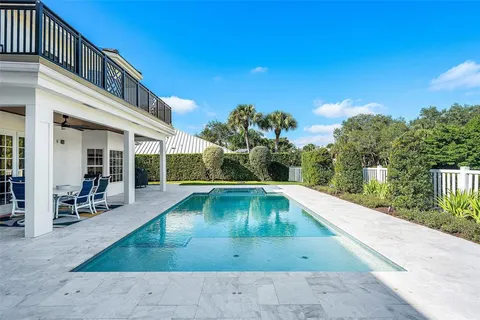 a front view of a house with a yard and a garden