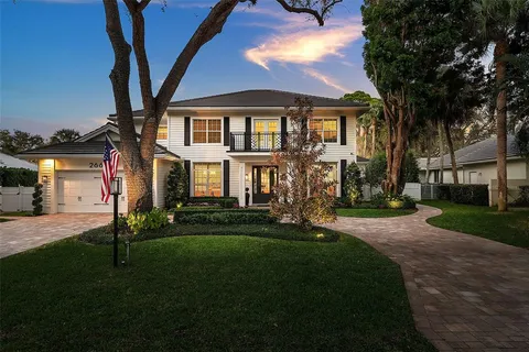 a front view of a house with a garden