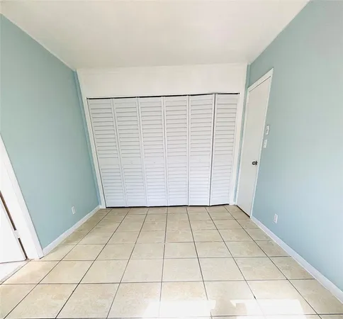 a view of a room with white walls and tiles