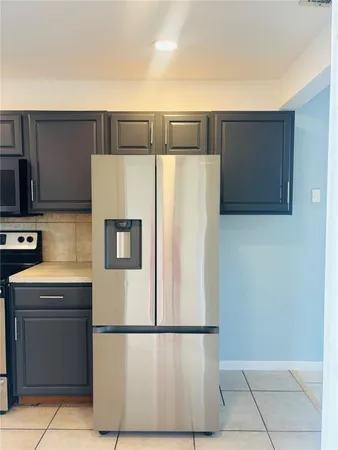 a white refrigerator freezer sitting in a kitchen