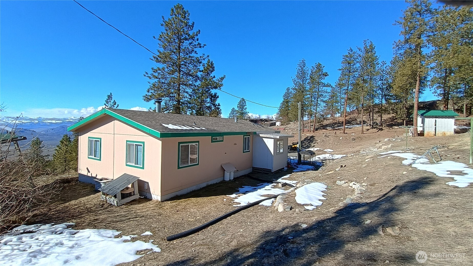 28 Ridgeline Road Tonasket, WA 98855 - Photo 2 of 19 a view of a white house with a yard