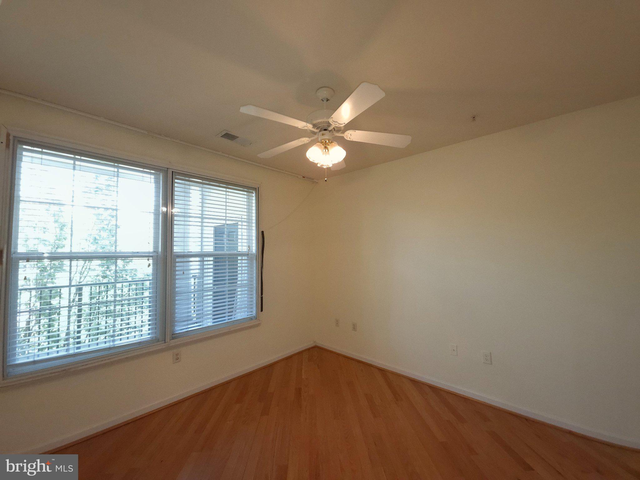 7 Booth Street, Unit 308 Gaithersburg, MD 20878 - Photo 10 of 21 wooden floor in an empty room with a window