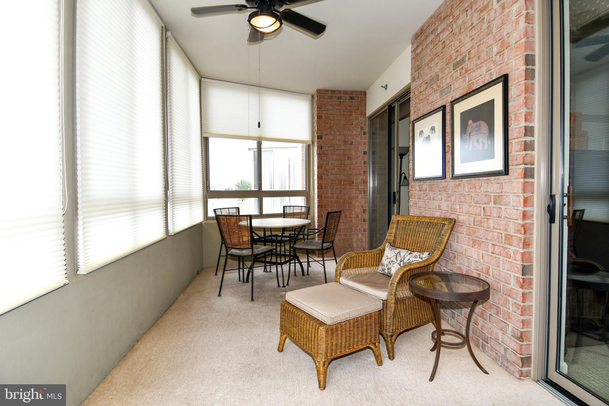 3210 North Leisure World Boulevard, Unit 519 Silver Spring, MD 20906 - Photo 11 of 64 a balcony with table and chairs