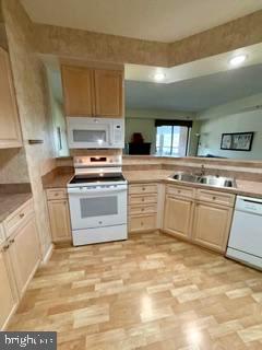 3210 North Leisure World Boulevard, Unit 519 Silver Spring, MD 20906 - Photo 14 of 64 a kitchen with a stove sink and cabinets