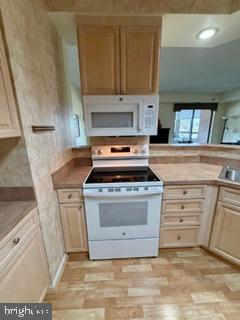 3210 North Leisure World Boulevard, Unit 519 Silver Spring, MD 20906 - Photo 15 of 64 a kitchen with granite countertop a stove and a sink
