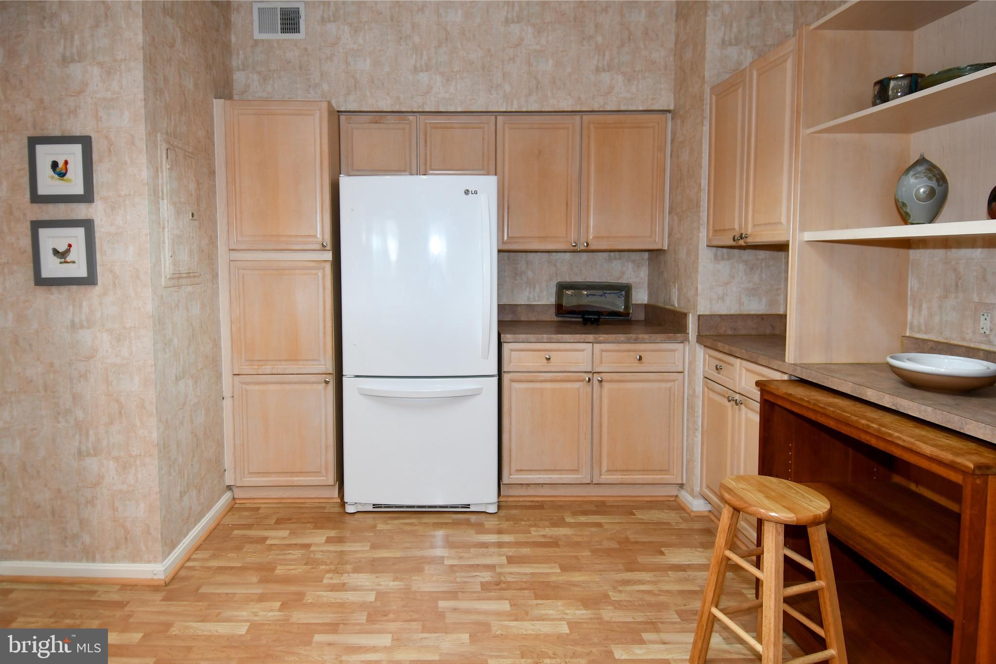 3210 North Leisure World Boulevard, Unit 519 Silver Spring, MD 20906 - Photo 16 of 64 a white refrigerator freezer sitting inside of a kitchen
