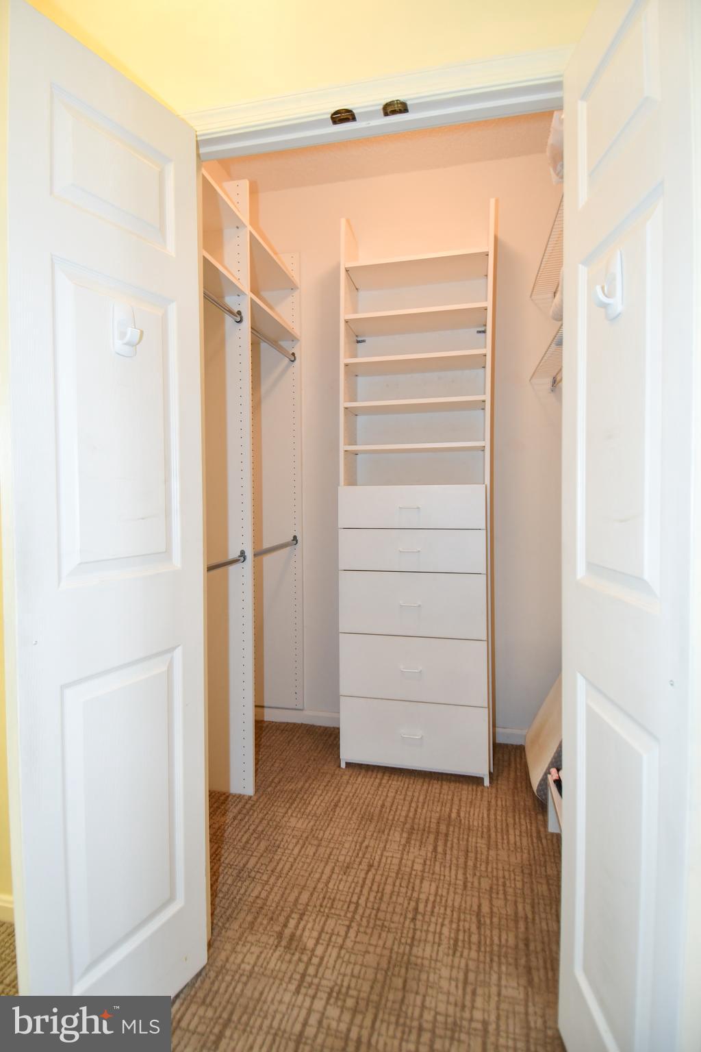 3210 North Leisure World Boulevard, Unit 519 Silver Spring, MD 20906 - Photo 22 of 64 a view of walk in closet with empty racks