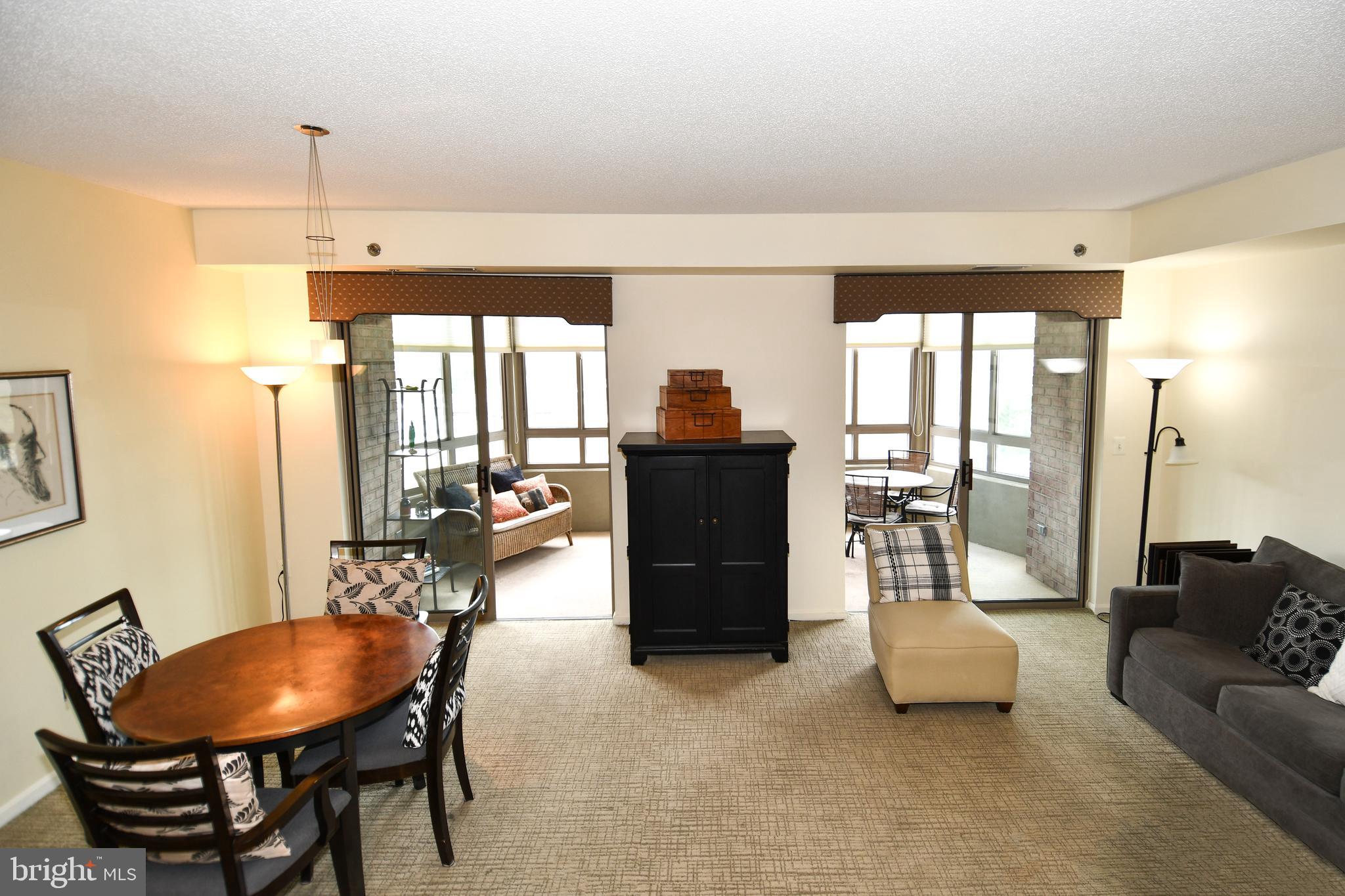 3210 North Leisure World Boulevard, Unit 519 Silver Spring, MD 20906 - Photo 4 of 64 a living room with furniture and a large window