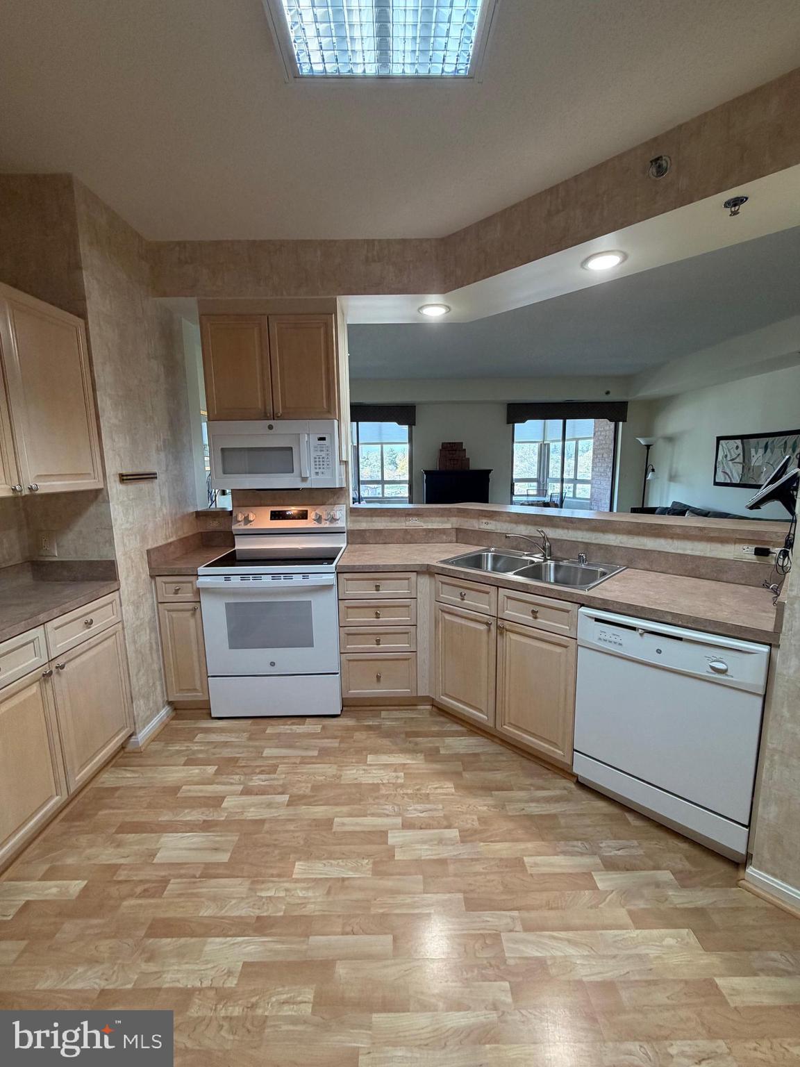 3210 North Leisure World Boulevard, Unit 519 Silver Spring, MD 20906 - Photo 58 of 64 a kitchen with a stove sink and cabinets