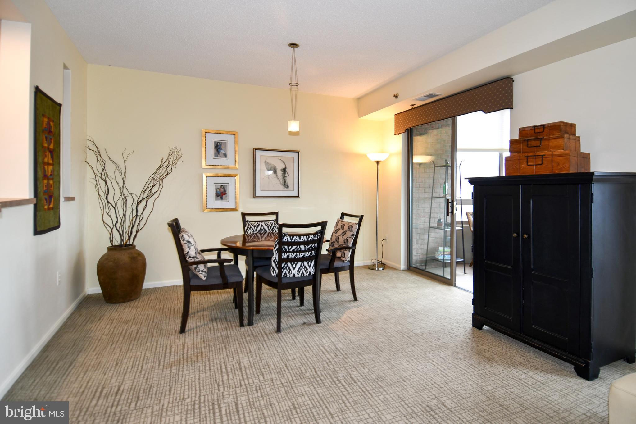 3210 North Leisure World Boulevard, Unit 519 Silver Spring, MD 20906 - Photo 7 of 64 a dining room with furniture and window