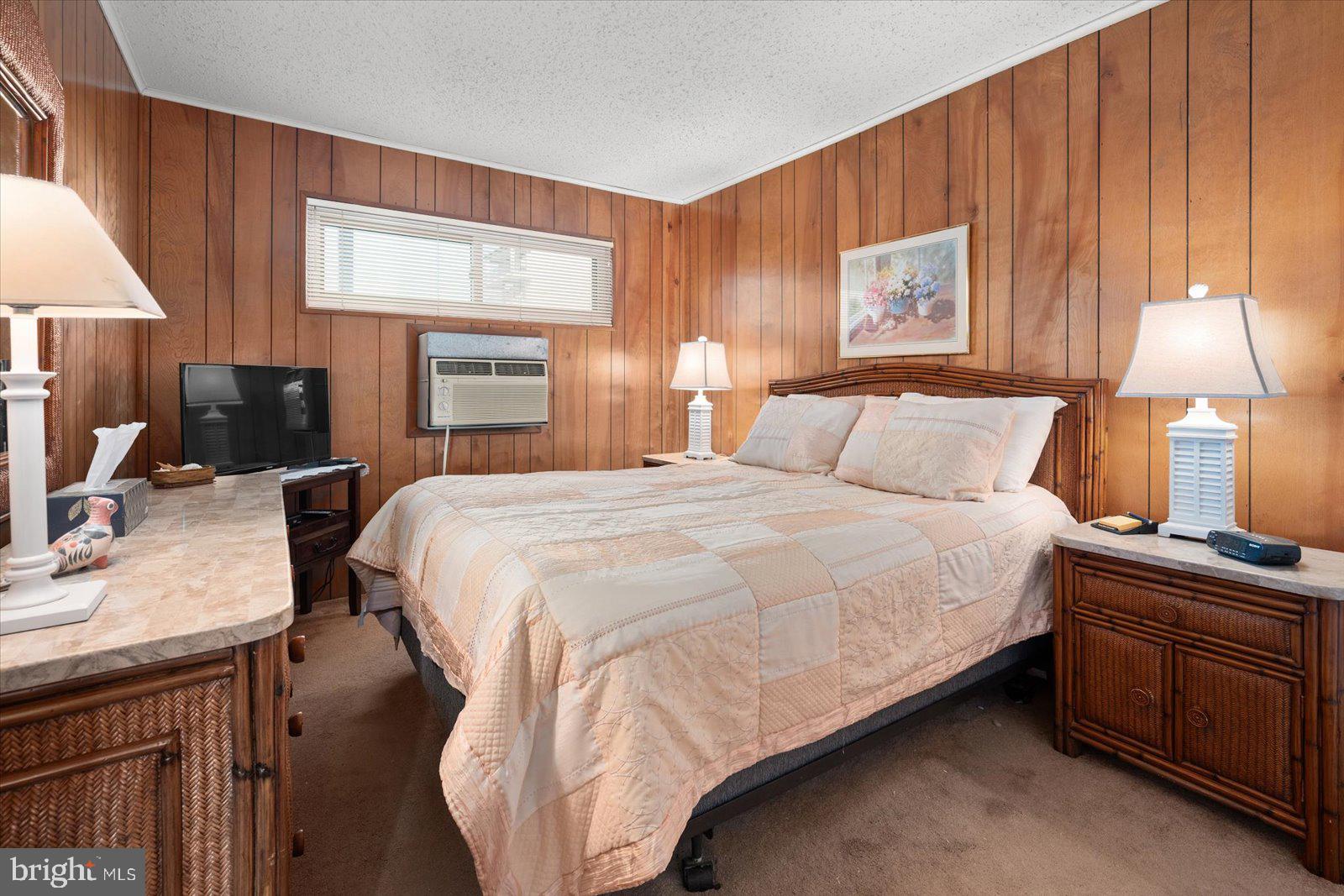 12 128th Street, Unit 2 Ocean City, MD 21842 - Photo 20 of 40 a bedroom with a bed and a lamp