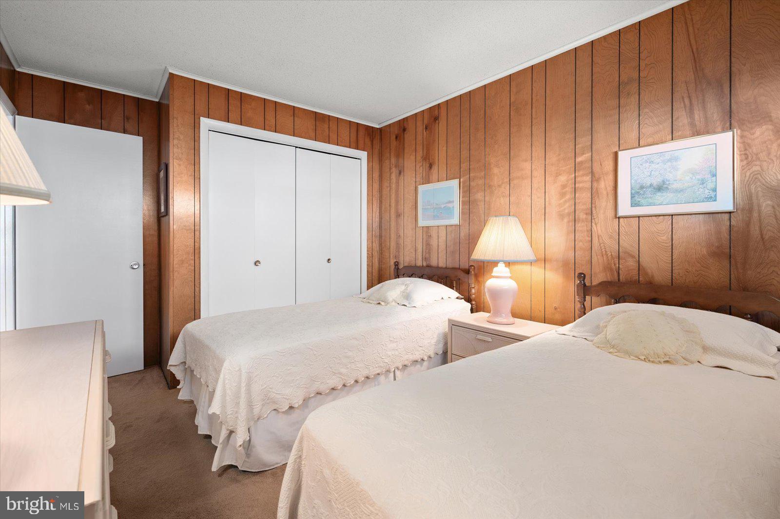 12 128th Street, Unit 2 Ocean City, MD 21842 - Photo 26 of 40 a bedroom with two beds and a lamp