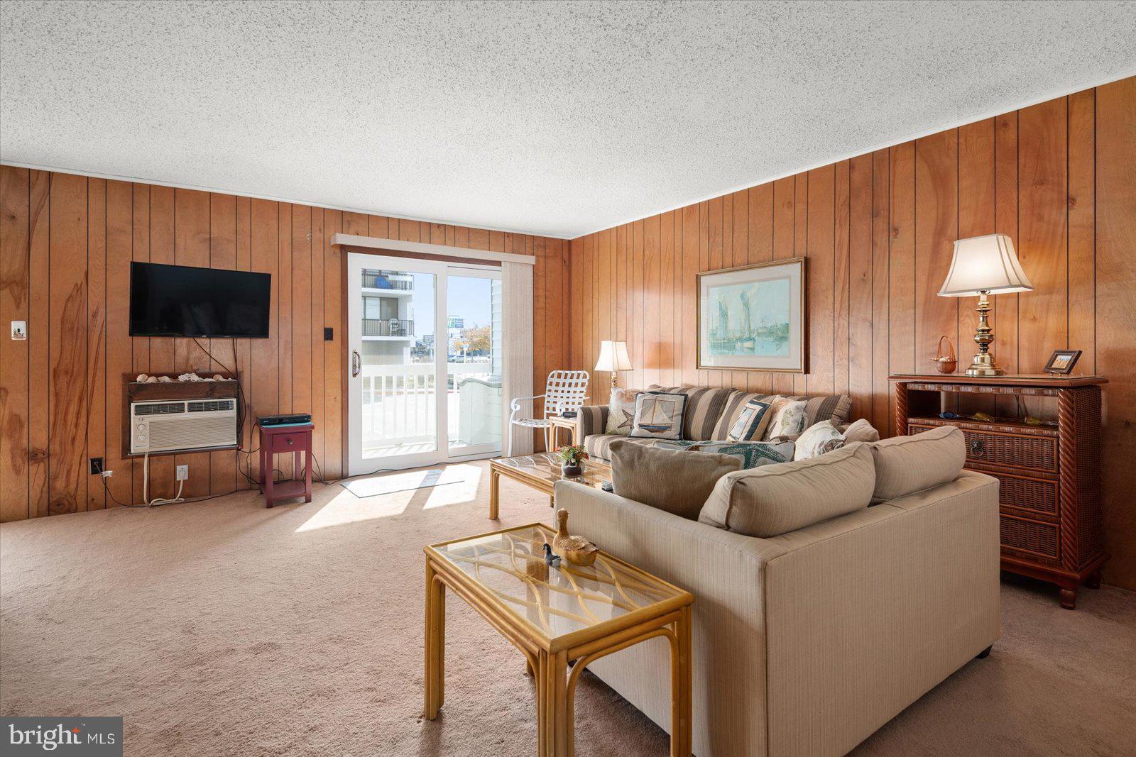 12 128th Street, Unit 2 Ocean City, MD 21842 - Photo 7 of 40 a living room with furniture and a flat screen tv