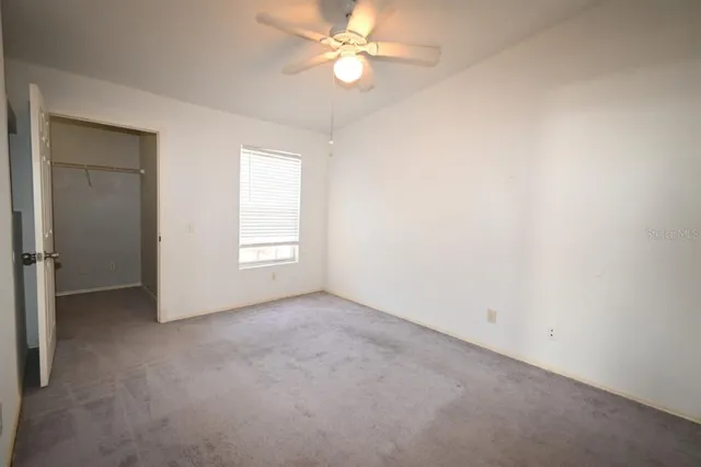 a bathroom with a granite countertop toilet sink and mirror