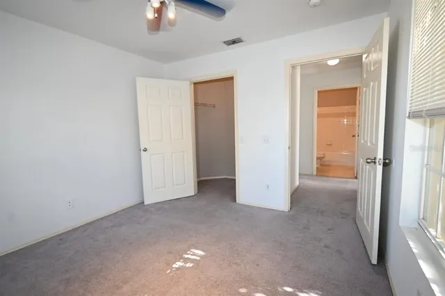 a sign that is sitting on a brick wall with plants