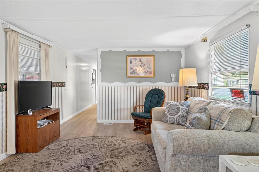 684 Cindi Avenue Leesburg, FL 34788 - Photo 23 of 60 a living room with furniture and a flat screen tv