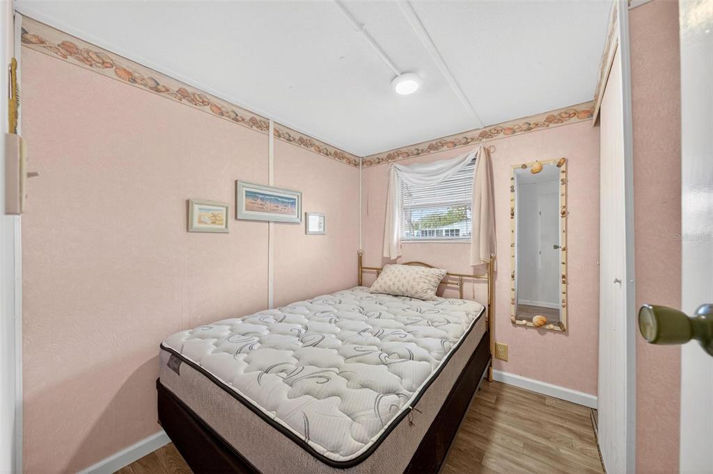 684 Cindi Avenue Leesburg, FL 34788 - Photo 24 of 60 a bedroom with a bed and a window