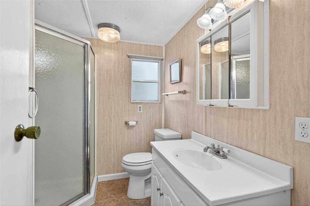 684 Cindi Avenue Leesburg, FL 34788 - Photo 27 of 60 a bathroom with a sink toilet and shower