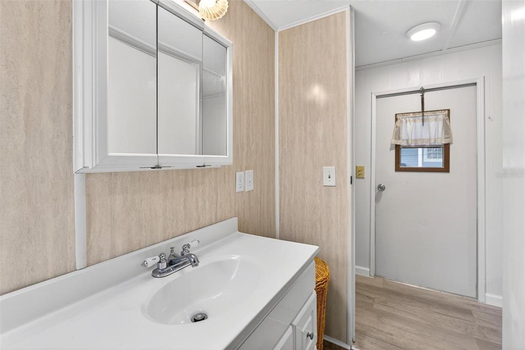 684 Cindi Avenue Leesburg, FL 34788 - Photo 29 of 60 a bathroom with a sink a mirror and a shower