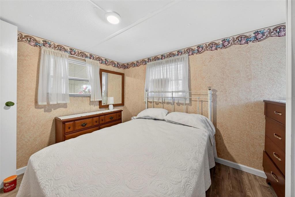 684 Cindi Avenue Leesburg, FL 34788 - Photo 31 of 60 a bedroom with a large bed and a window