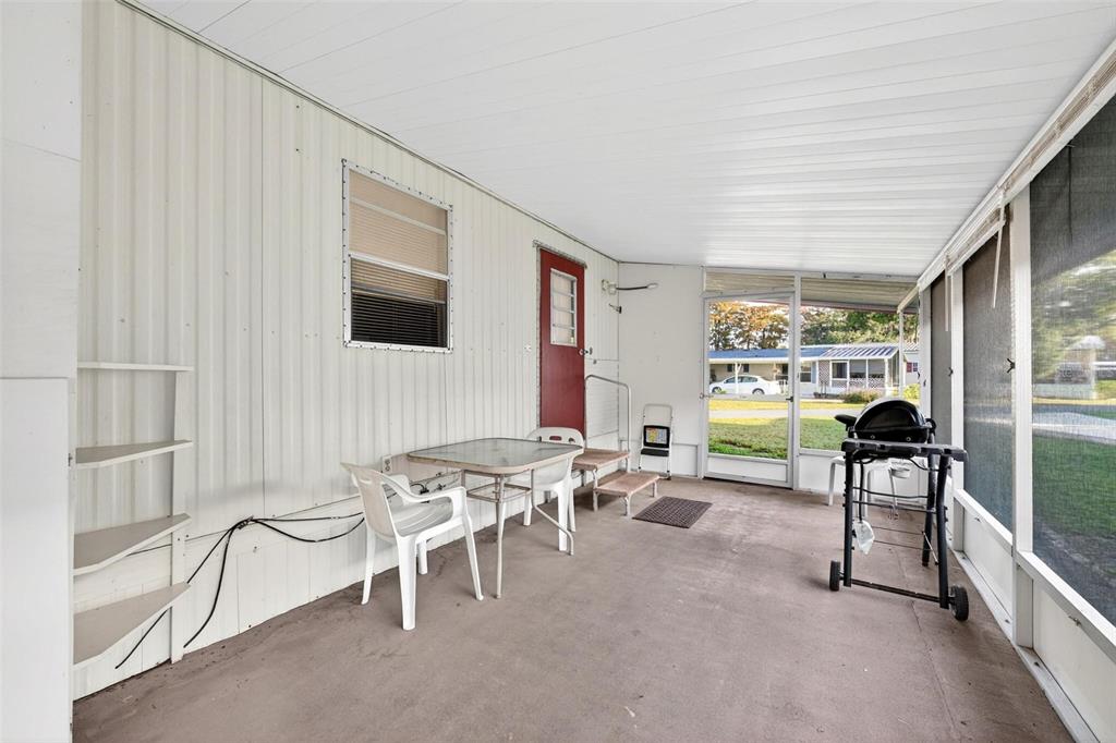 684 Cindi Avenue Leesburg, FL 34788 - Photo 7 of 60 a living room with furniture a flat screen tv and a table