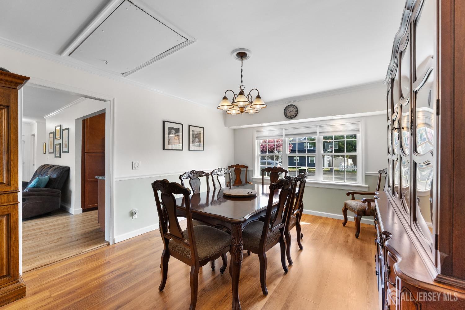 9 Pine Tree Road Old Bridge, NJ 08857 - Photo 26 of 46 a dining room with wooden floor a chandelier a wooden table and chairs