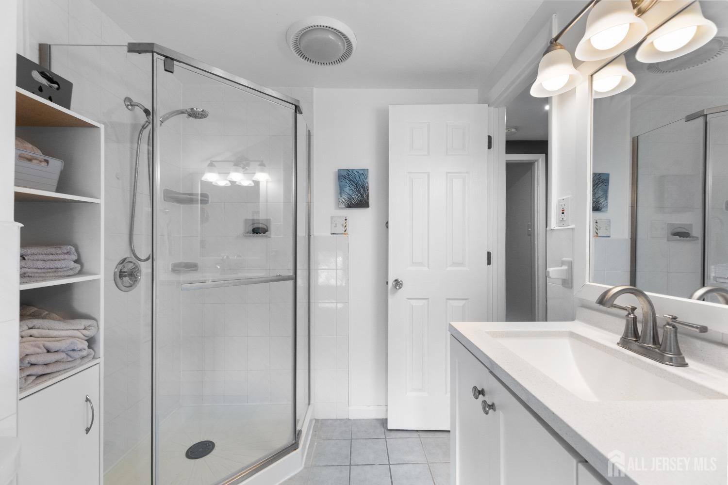 9 Pine Tree Road Old Bridge, NJ 08857 - Photo 29 of 46 a bathroom with a shower sink and mirror
