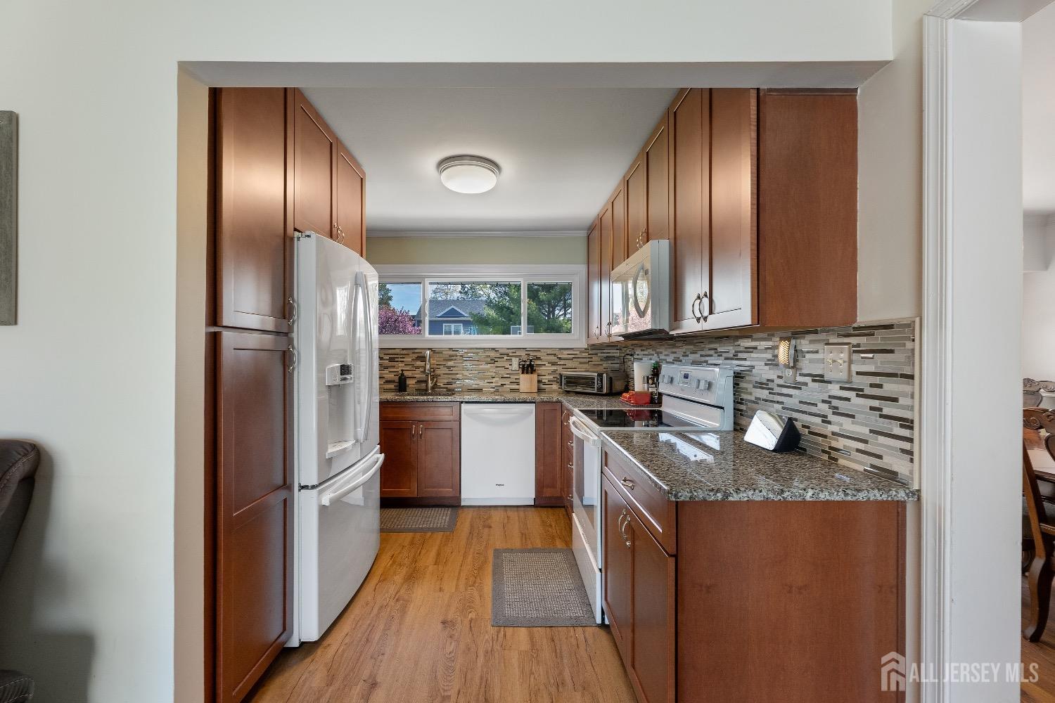 9 Pine Tree Road Old Bridge, NJ 08857 - Photo 31 of 46 a kitchen with granite countertop stainless steel appliances a refrigerator stove top oven and sink