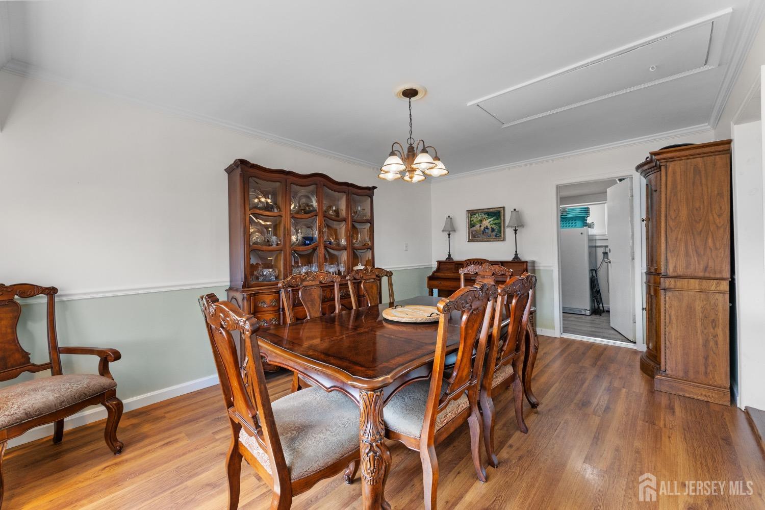 9 Pine Tree Road Old Bridge, NJ 08857 - Photo 34 of 46 a dining room with furniture a chandelier and wooden floor